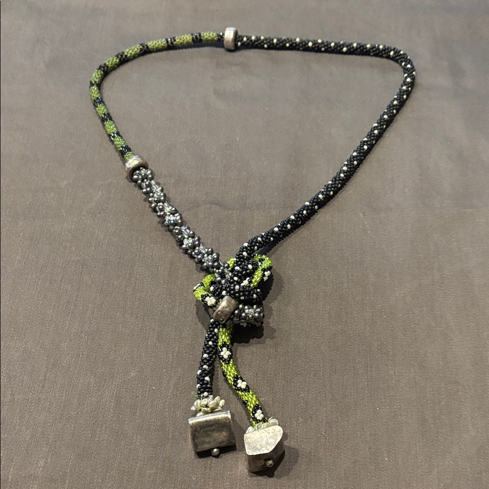 Woven bead necklace with silver detail.